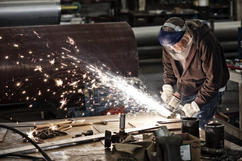 worker grinding sheet metal