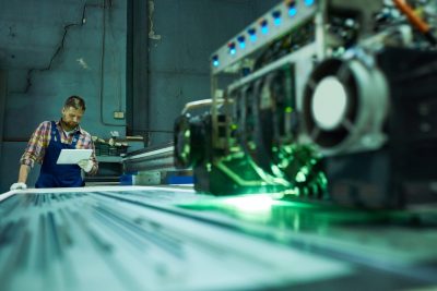 laser engraving metal, young man working on machine 