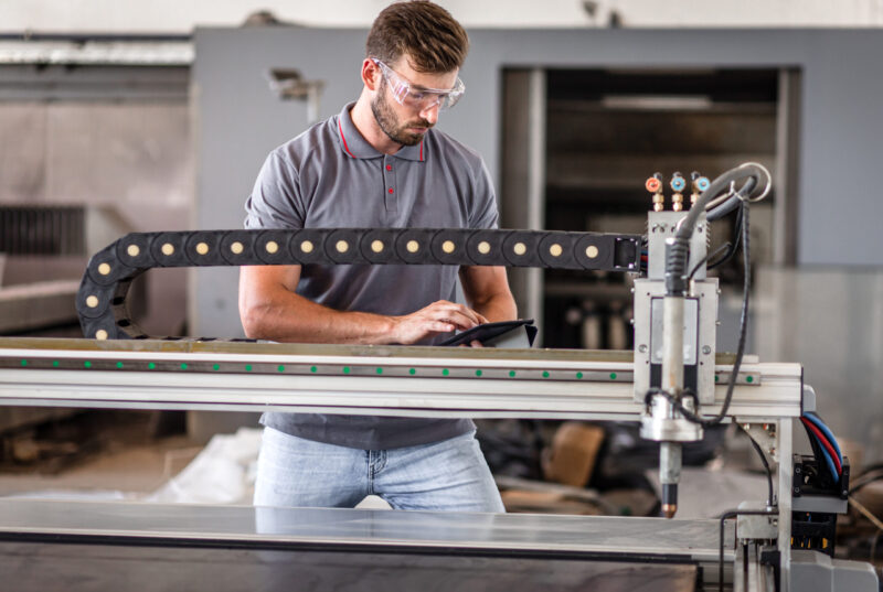 engineer working on a plasma cutter for metal, plasma cutting