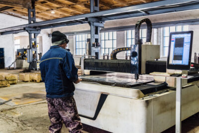 engineer working on CNC laser cutting machine 