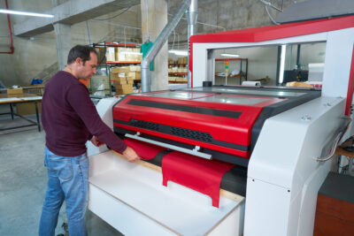 engineer working on laser cutting machine for laser cut projects 