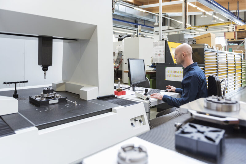 engineer working on CNC laser cutting machine