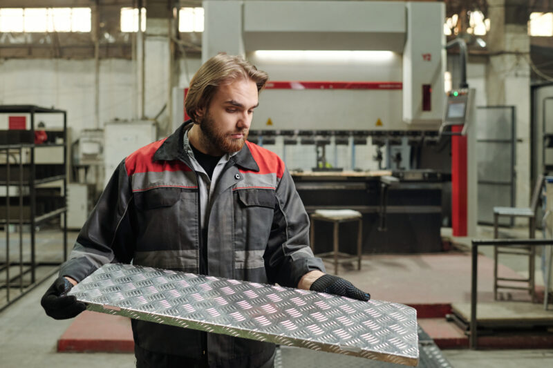 engineer holding different metal material for metal fabrication project