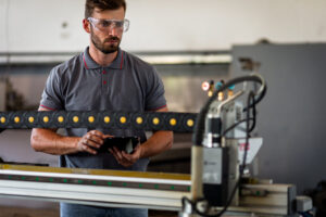 engineer using plasma laser cutting machine 